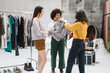 © Garage Island Crew/Stocksy - Women friends during shopping in a temporary store