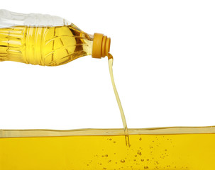 Pouring cooking oil from bottle on white background