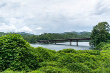 The Old Rusty Bridge Is Seen In The Distance As The Train Comes Around The Tracks To Travel Over The River In The Mountains Of North Carolina.