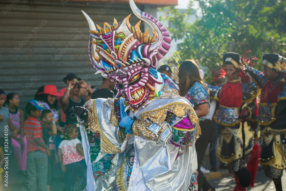 native man defile in colorful costume at dominican traditional carnival annual event - obrazy, fototapety, plakaty 