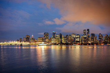 Wall Mural - View of buildings illuminated in the city on coastline from Stanley park at Vancouver