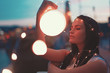 Young brunette woman playing with fairy lights outdoors moody moments