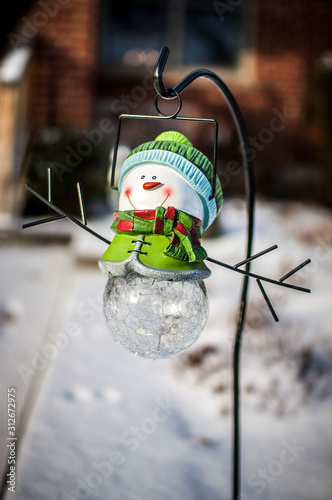 A little iceman ornament in a yard covered in snow Tableau sur Toile
