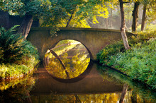 Stone Old Bridge Reflection In The Form Of A Circle In Water Of A Canal In A Park, Den Bosch, The Netherlands