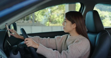 Canvas Print - Woman set up the gps location on cellphone inside on car