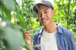 © Heru - Happy of young Asian farmer male holding the long beans