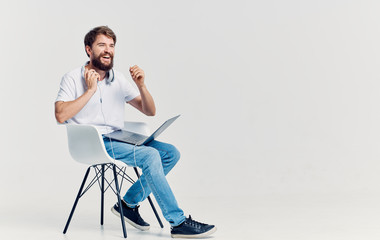 Wall Mural - woman sitting on chair and working on laptop