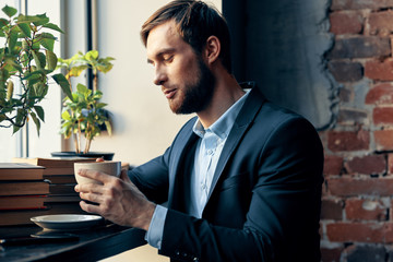 Wall Mural - businessman drinking coffee in cafe