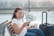 © Song_about_summer - travel app, woman using mobile smart phone in airport, passenger waiting in gate terminal or railway station