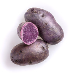 Wall Mural - Raw purple potatoes isolated on white background. Top view, close-up.