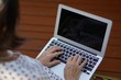 © plo - An old asian woman sititing on the chair using laptop