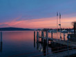 the pier where the ferries operating on Lake Maggiore land at sunset. Arona - Piedmont