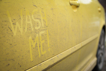 Write the words inscription text wash me on the very dirty surface of the car. Concept car wash.