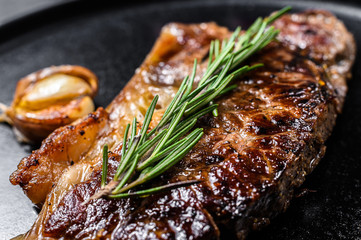 Wall Mural - beef new york strip steak on black background. space for text. marble premium beef. close up.