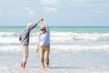 Wall Mural - Happy asian couple dancing on the beach enjoy  life