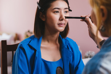 Beautiful young asian woman and professional makeup artists applies eye shadow. Beautiful woman face. Perfect makeup, Natural make up, Facial treatment, Perfect skin