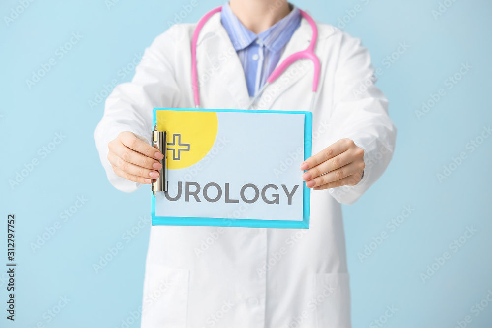 Doctor holding paper with text UROLOGY on light background