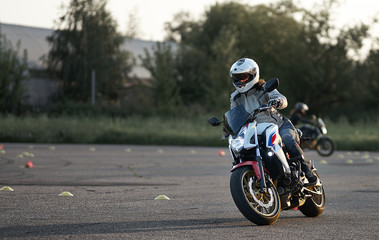 Wall Mural - Gymkhana training day. Girl trainings ride motocycle