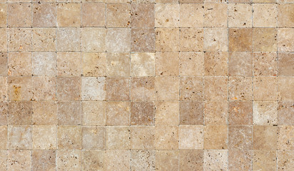Seamless wall background with Yellow natural sandstone tiles stitched together with clay