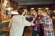 Men Fight In A Pub Bar.