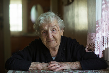 Wall Mural - Home portrait of an elderly gray-haired granny woman.