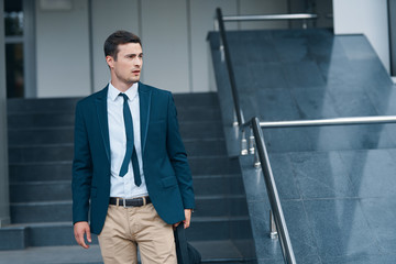 Poster - businessman standing in office corridor