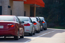 Generic Drive Thru Pickup Window With Cars Waiting In Line To Get Their Products Or Food