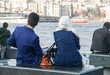 © jummie - young couple sit on the bench at pier in Bosphorus in Turkey