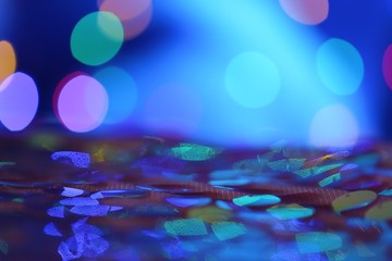 Blue bokeh background. Deep blue color.  Large sequins on a blurry blue background with bokeh.panton 2020 classic blue.glitter blue gradient texture with bokeh. 