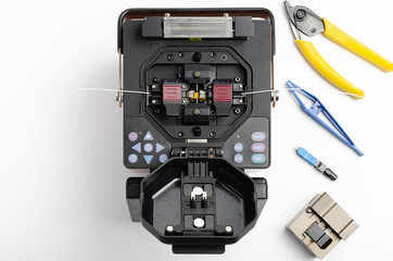 Welding machine and tool kit for stripping and welding of optical fiber