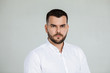 © Rychko Yevhen - calm handsome bearded man poses in studio on gray background