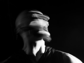 Portrait of a  man screaming in soft focus and long exposure