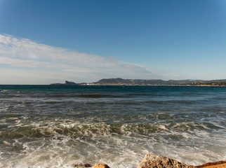 View on Mediterranean sea, shores, calanques and waterfront landscape of La Ciotat, eagle's beak, calanque du Mugel from Sandy beach at Les Lecques in Saint-Cyr-sur-Mer in French Riviera