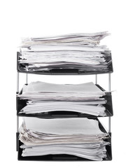 Office paper filing trays isolated on white background. Lots of paperwork, work, bureaucracy.