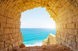 Ancient stone arch overlooking the blue tropic sea.