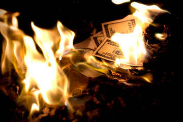 Wall Mural - US Dollars in fire. One hundred dollar banknotes burning. Dollars in flames..