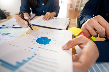 Wall Mural - Business People Talking Discussing with coworker planning analyzing financial document data charts and graphs in Meeting and successful teamwork Concept.