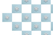 White wooden snowflakes on a gentle blue background. Chess squares blue and white. Pattern. The background. Screensaver.