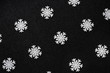 White wooden snowflakes on a black sparkling background. Geometric arnaments. Pattern. The background. Screensaver.