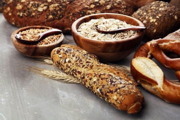 Wall Mural - Assortment of baked bread and bread rolls and cutted bread on table background