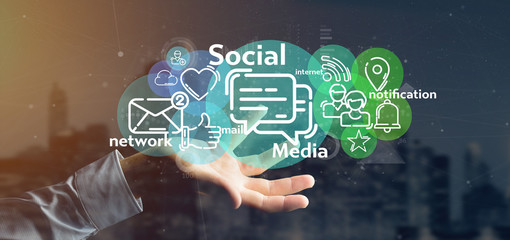 Businessman holding a cloud of social media network icon