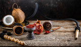 Fototapeta Mapy - Stone hookah head on old rustic table with fruit flavoured tobacco