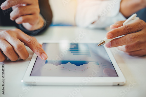 Fotomural businessman investment consultant analyzing company financial report balance sheet statement working with digital graphs