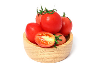 Closeup fresh Tomato in a wooden bowl isolated on white background with clipping path