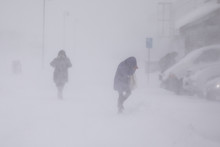 Blizzard In Longyearbyen . People In Snowfall. Abstract Blurry Winter Weather Background