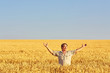 © Ryzhkov Oleksandr - Farmer walking through a golden wheat field