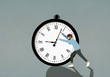 © fStop - Man pushing hands of large stopwatch