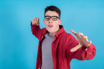 Poster - young man or teenage student isolated on color background with a challenging and aggressive expression