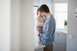 © Johnér - Father with baby in kitchen