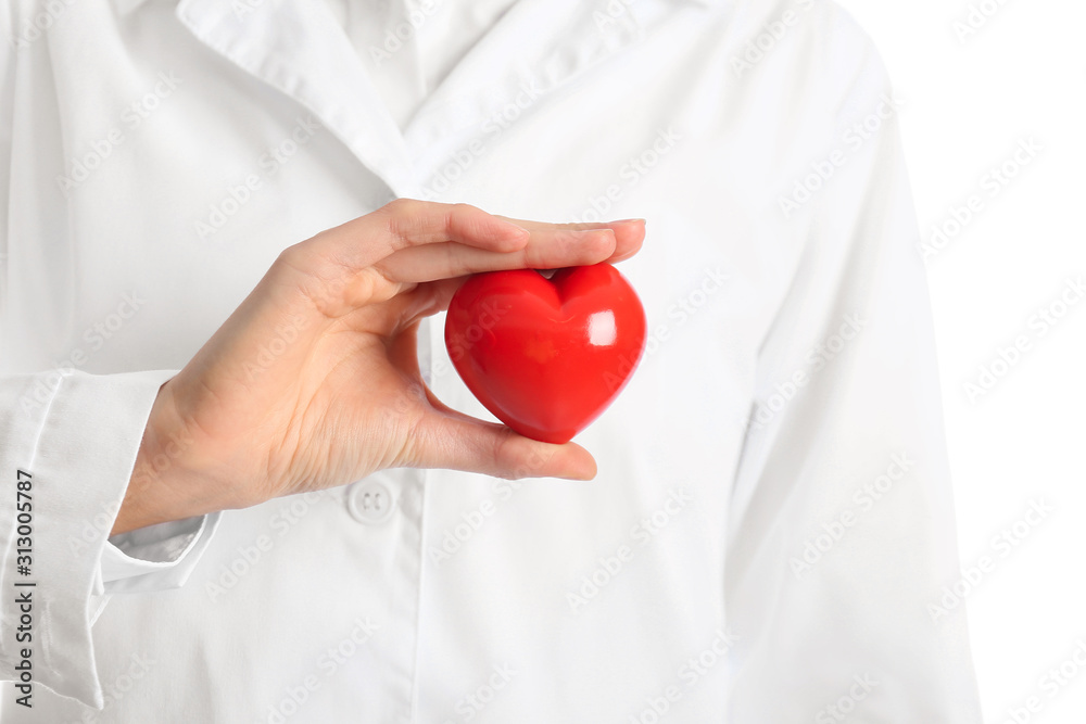 Female cardiologist with red heart on white background, closeup